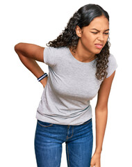 Young african american girl wearing casual clothes suffering of backache, touching back with hand, muscular pain
