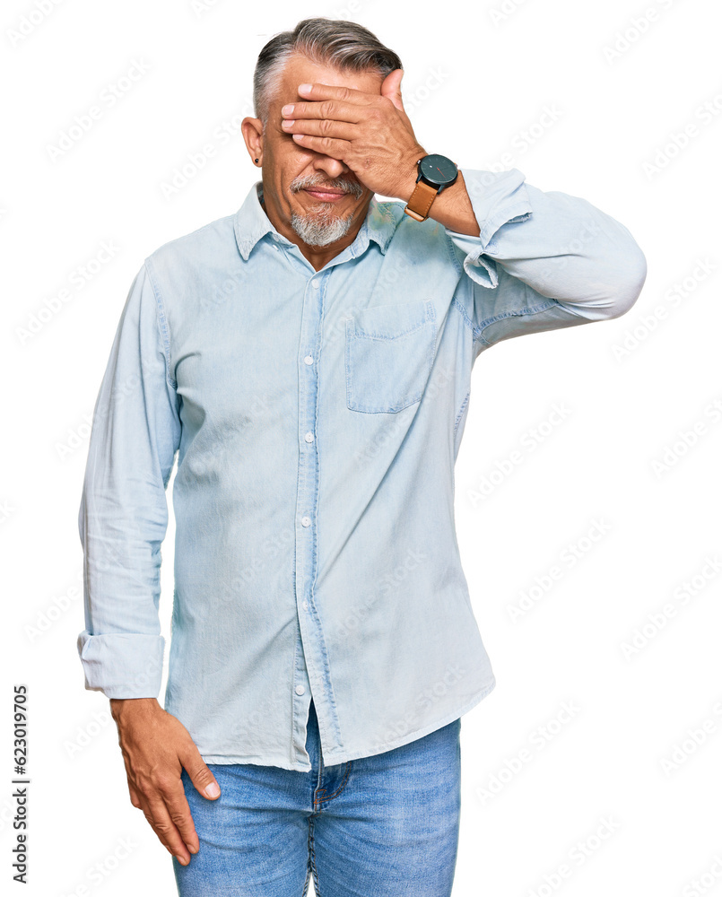 Poster Middle age grey-haired man wearing casual clothes covering eyes with hand, looking serious and sad. sightless, hiding and rejection concept