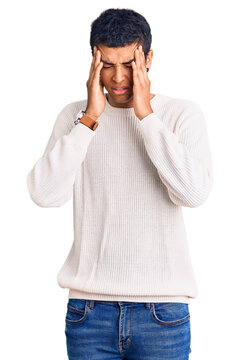 Young african amercian man wearing casual clothes with hand on head, headache because stress. suffering migraine.
