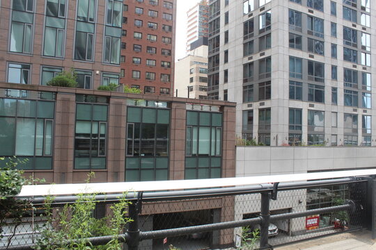 A photo of buildings and a bridge railing in New York City. 