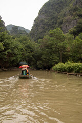 Tourist on the Tam Coc river