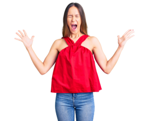 Beautiful brunette young woman wearing casual clothes celebrating mad and crazy for success with arms raised and closed eyes screaming excited. winner concept