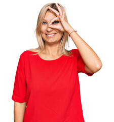 Middle age caucasian woman wearing casual clothes doing ok gesture with hand smiling, eye looking through fingers with happy face.