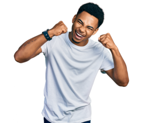 Young african american man wearing casual white t shirt angry and mad raising fists frustrated and furious while shouting with anger. rage and aggressive concept.