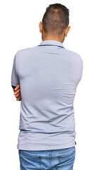 Fototapeta premium Handsome man with beard wearing casual clothes standing backwards looking away with crossed arms