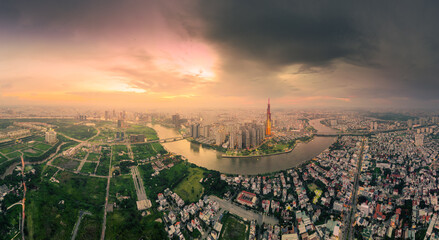 Aerial view of a Ho Chi Minh City, Vietnam with development buildings, transportation, energy power infrastructure. Financial and business centers. Sunset to night.