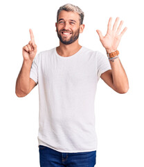 Fototapeta premium Young handsome blond man wearing casual t-shirt showing and pointing up with fingers number six while smiling confident and happy.