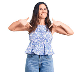 Young beautiful brunette woman wearing casual t-shirt looking confident with smile on face,...
