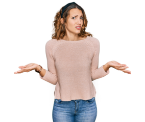 Beautiful young caucasian woman wearing casual sweater clueless and confused with open arms, no idea concept.