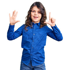 Cute child with long hair wearing casual clothes showing and pointing up with fingers number seven while smiling confident and happy.