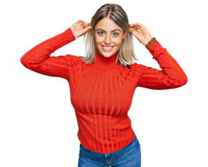 Beautiful blonde woman wearing casual clothes smiling pulling ears with fingers, funny gesture. audition problem