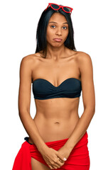 Young african american woman wearing bikini depressed and worry for distress, crying angry and afraid. sad expression.