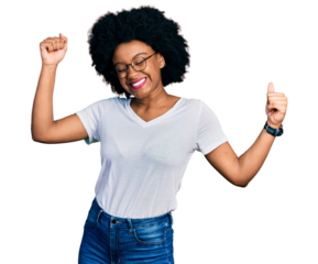 Young african american woman wearing casual white t shirt dancing happy and cheerful, smiling moving casual and confident listening to music