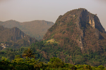 The background of the sea by the evening sea, with natural beauty (sea water, rocks, sky) and fishermen are fishing by the river bank, is a pleasure during travel.