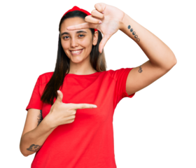 Young hispanic woman wearing casual clothes smiling making frame with hands and fingers with happy face. creativity and photography concept.