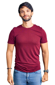 Handsome hispanic man wearing casual clothes relaxed with serious expression on face. simple and natural looking at the camera.