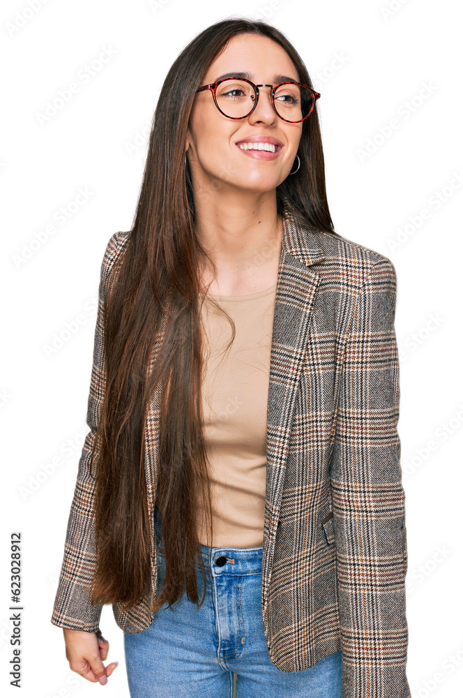 Wall mural Young hispanic girl wearing business clothes and glasses looking away to side with smile on face, natural expression. laughing confident.