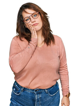 Young plus size woman wearing casual clothes and glasses thinking looking tired and bored with depression problems with crossed arms.