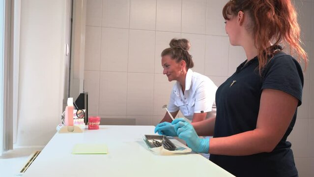 Female Doctor and assistant working in medical office in clinic. Medicine paperwork, study patients disease card history Health care workers routine