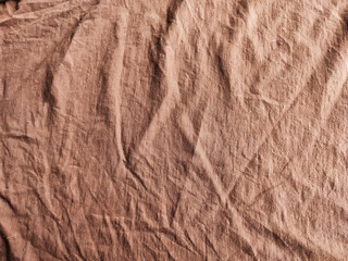 Abstract background and texture of crumpled brown satin fabric. Texture, pattern, frame, copy space