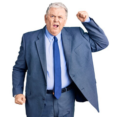 Senior grey-haired man wearing business jacket angry and mad raising fist frustrated and furious while shouting with anger. rage and aggressive concept.