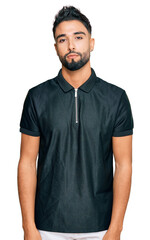 Fototapeta premium Young man with beard wearing sportswear relaxed with serious expression on face. simple and natural looking at the camera.