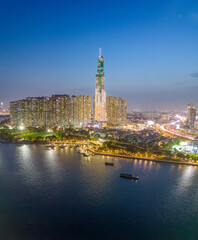 Obraz premium Aerial view of a Ho Chi Minh City, Vietnam with development buildings, transportation, energy power infrastructure. Financial and business centers. Sunset to night.