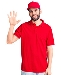 Young handsome man with beard wearing delivery uniform showing and pointing up with fingers number five while smiling confident and happy.
