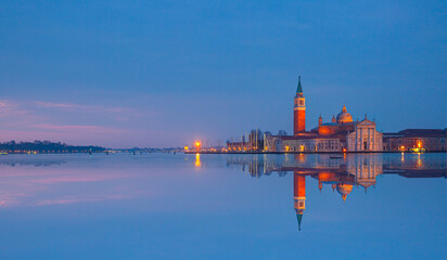 View of San Giorgio Island in Venice with wooden buoys in Giudecca Canal  at twilight blue hour - Venetian gondolier  © muratart