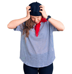 Young beautiful blonde woman wearing french beret and striped t-shirt suffering from headache...