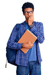 Young african american man wearing student backpack holding book looking stressed and nervous with hands on mouth biting nails. anxiety problem.