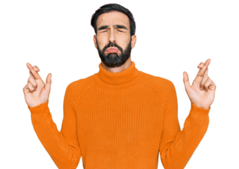 Young hispanic man wearing casual clothes gesturing finger crossed smiling with hope and eyes closed. luck and superstitious concept.