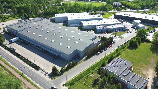 Aerial view of distribution center, drone photo of industrial logistics zone,new super modern logistics center full of modern technology and robotics,roof solar power plant for green energy production