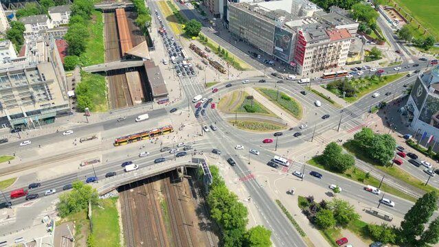 Vehicles on a busy roundabout junction. Traffic circle with a lot of cars. Top down aerial view on a circular intersection in