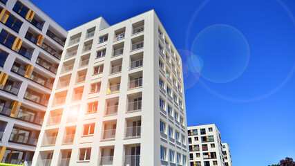 Contemporary residential building exterior in the daylight. Modern apartment buildings on a sunny day with a blue sky. Facade of a modern apartment building. 