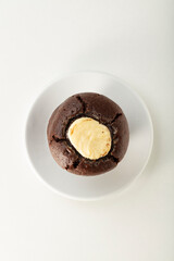 Muffin de chocolate con helados de vainilla, vista cenital. Chocolate muffin with vanilla ice cream, overhead view.