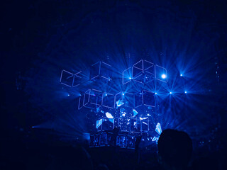 An abstract set on a stage in neon lights.