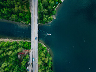 Aerial view of bridge asphalt road with car and blue water lake with boat. Beautiful summer...