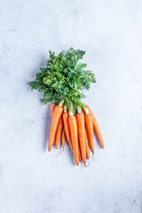 Bunch of fresh carrots. Flat lay, view from the top, vertical orientation