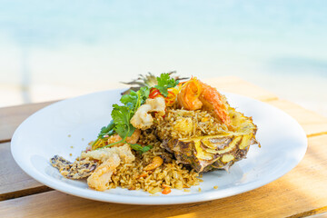 Seafood fried rice in pineapple, appetizing in a cafe next to the sea, Sue Flamingo, Ao Yon Beach, Phuket Thailand