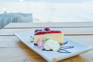 Appetizing white blueberry cake in a cafe next to the sea, Sue Flamingo, Ao Yon Beach, Phuket...