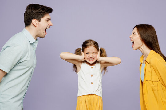 Young Sad Parent Mom Dad With Child Kid Girl 6 Year Old Wear Blue Yellow Casual Clothes Covering Ear With Hands Fingers Do Not Want Listen Scream Isolated On Plain Purple Background Family Day Concept