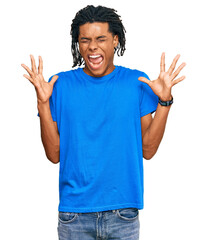 Young african american man wearing casual clothes celebrating mad and crazy for success with arms...