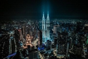 Fototapeta na wymiar Tours Jumelles Petronas Tower et Ville de Kuala Lumpur la nuit dans une lumière bleutée et blanche. architecture moderne et futuriste, Malaisie