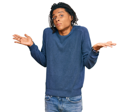 Young african american man wearing casual winter sweater clueless and confused expression with arms and hands raised. doubt concept.