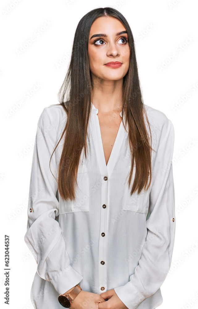 Wall mural young beautiful woman wearing casual white shirt smiling looking to the side and staring away thinki