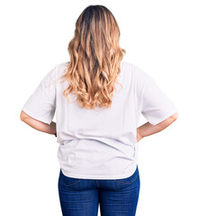 Young caucasian woman wearing casual clothes standing backwards looking away with arms on body