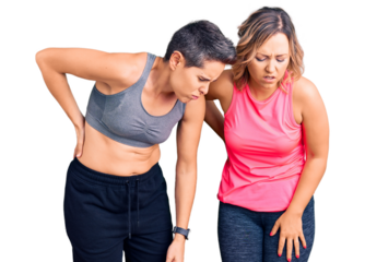 Couple of women wearing sportswear suffering of backache, touching back with hand, muscular pain