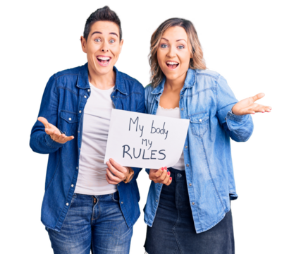 Couple of women holding my body my rules banner celebrating victory with happy smile and winner expression with raised hands