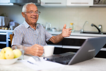 Senior man talking with his relatives through video call